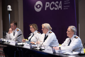 Four senior gardaí seated at a table