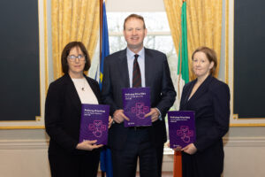 CEO of PCSA Helen Hall, Minister for Justice, Home Affairs and Migration Jim O'Callaghan, and PCSA Chairperson Elaine Byrne standing together holding the Policing Priorities. 